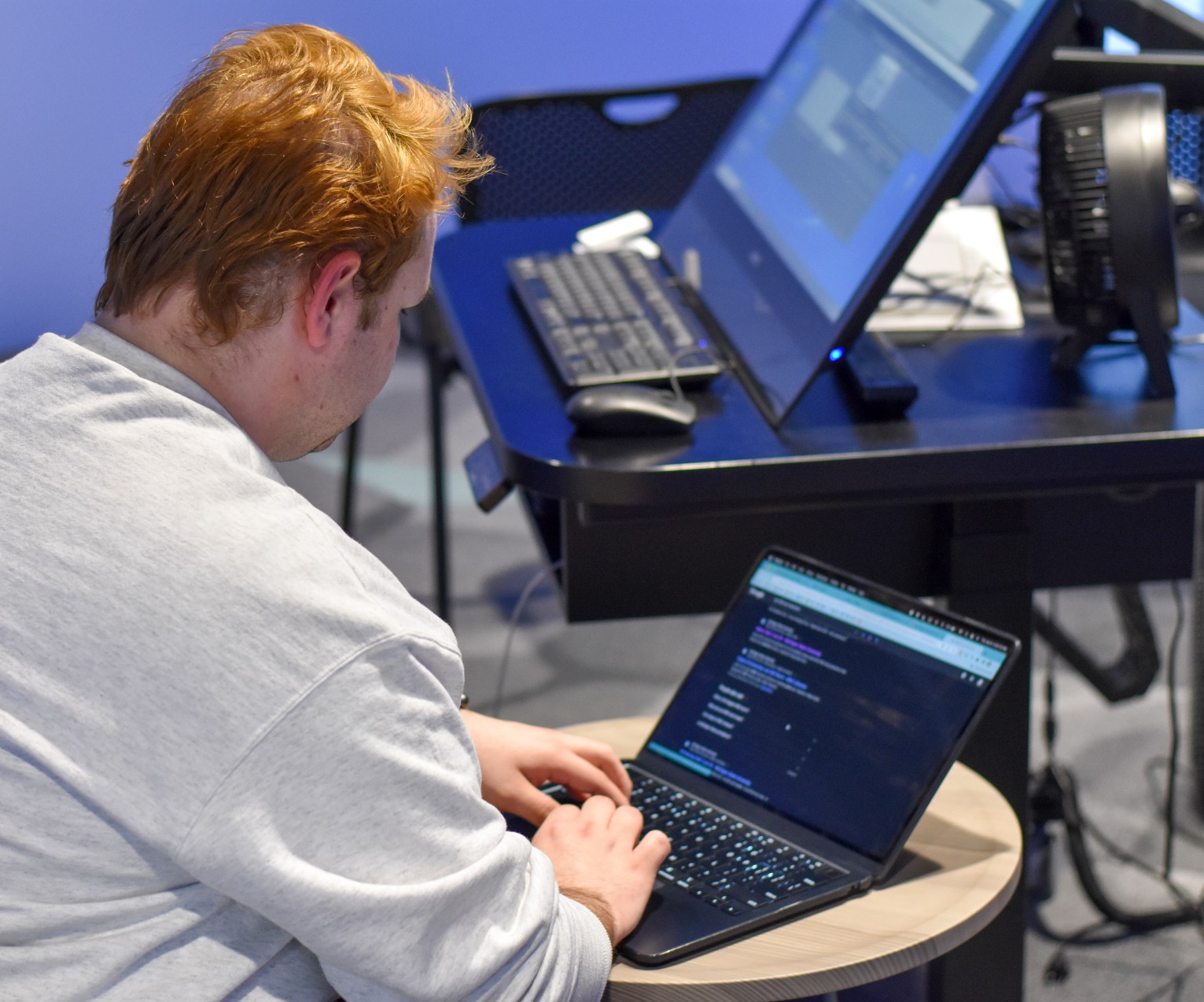 Student Michael Griffin works on the exhibit on his laptop.